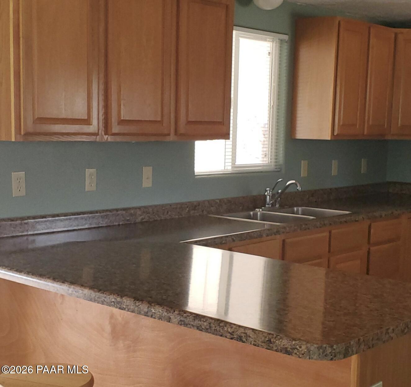 20817 East Butterfield Road Mayer, AZ 86333 - Photo 21 of 24 a kitchen with granite countertop white cabinets sink and window
