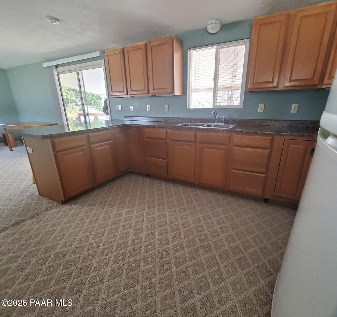 20817 East Butterfield Road Mayer, AZ 86333 - Photo 22 of 24 a kitchen with granite countertop a sink window and cabinets