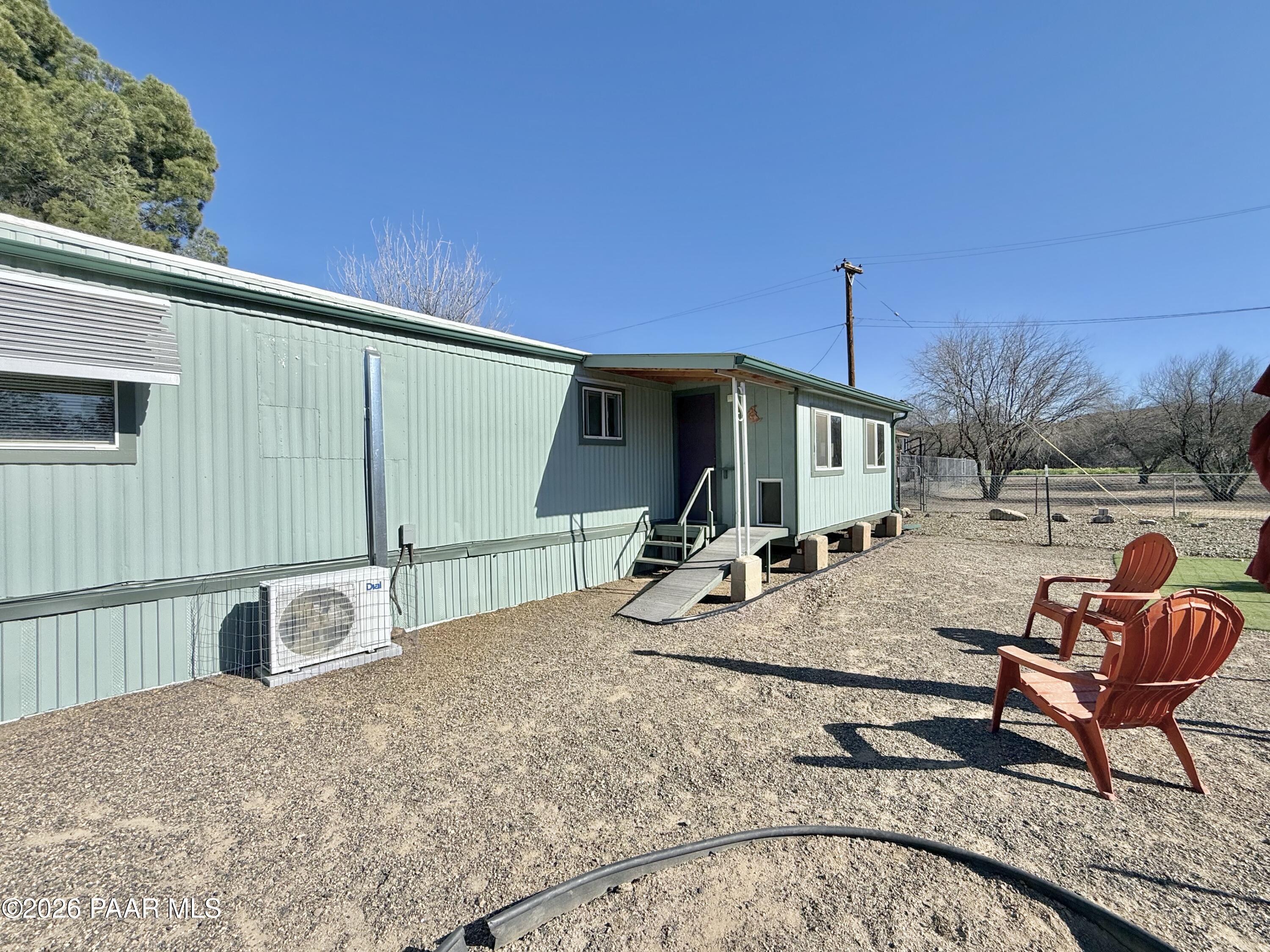 20817 East Butterfield Road Mayer, AZ 86333 - Photo 6 of 24 a backyard of a house with table and chairs
