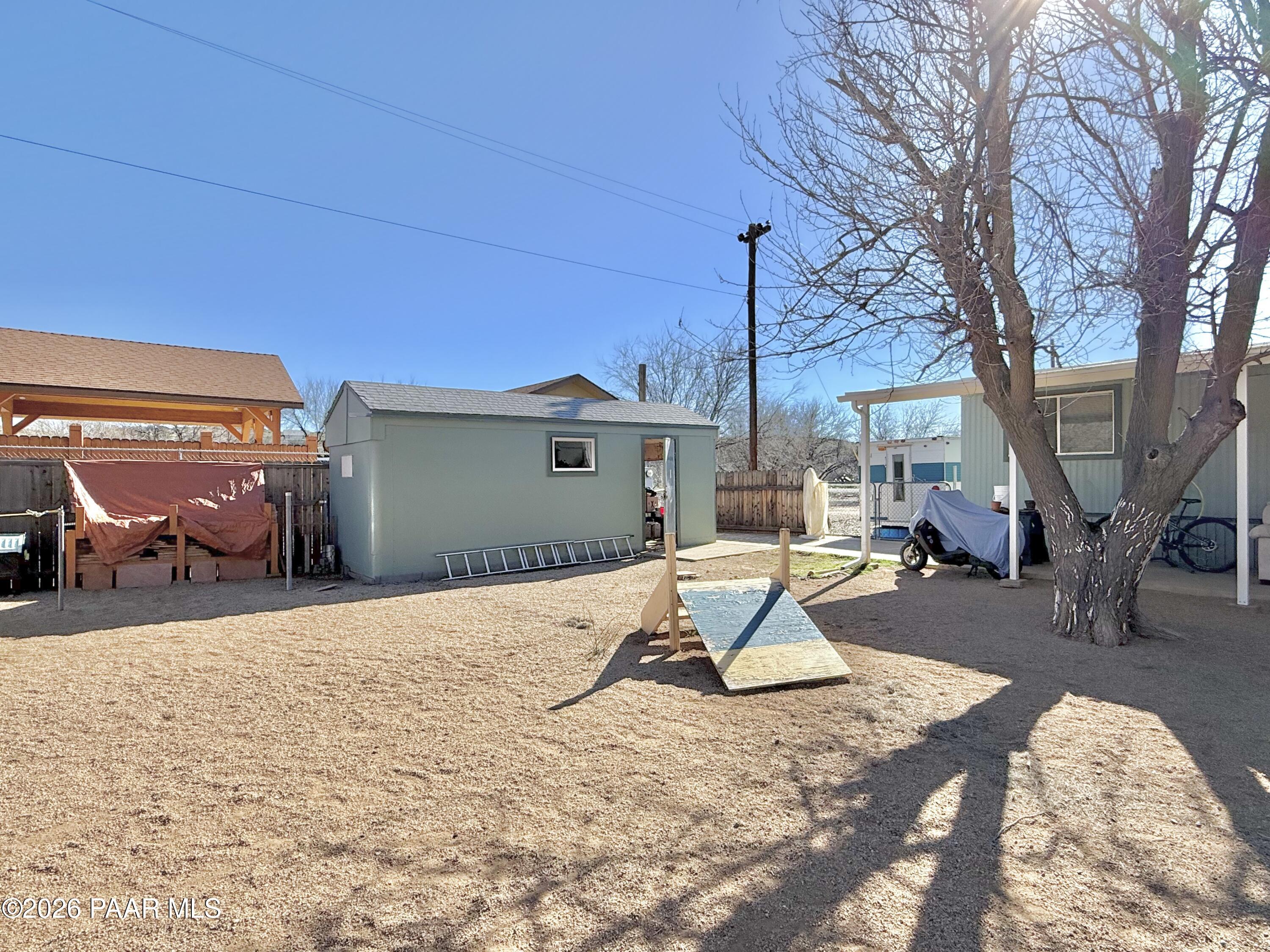 20817 East Butterfield Road Mayer, AZ 86333 - Photo 8 of 24 a view of a house with backyard porch and sitting area