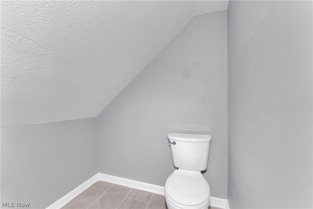 3925 Riverside Avenue Cleveland, OH 44109 - Photo 37 of 46 White porcelain toilet with a white tank and handle