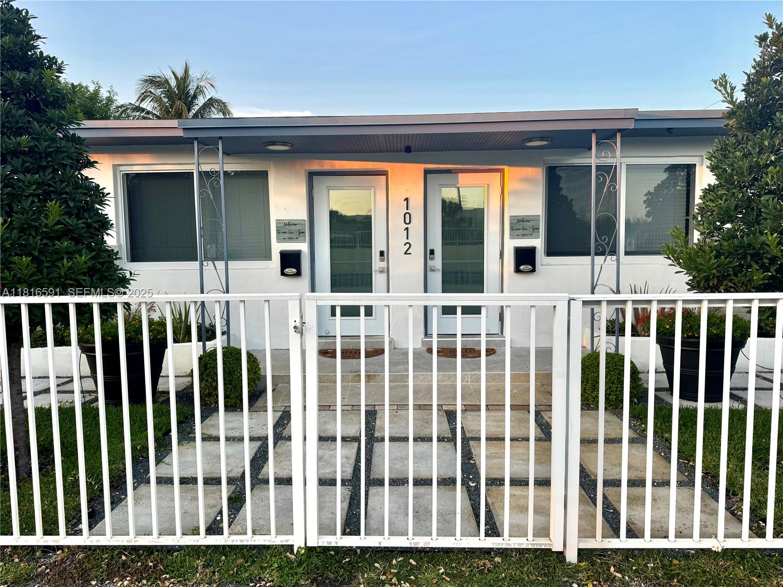 1012 Southwest 3rd Avenue Hallandale Beach, FL 33009 - Photo 1 of 35 a view of a house with a wooden deck