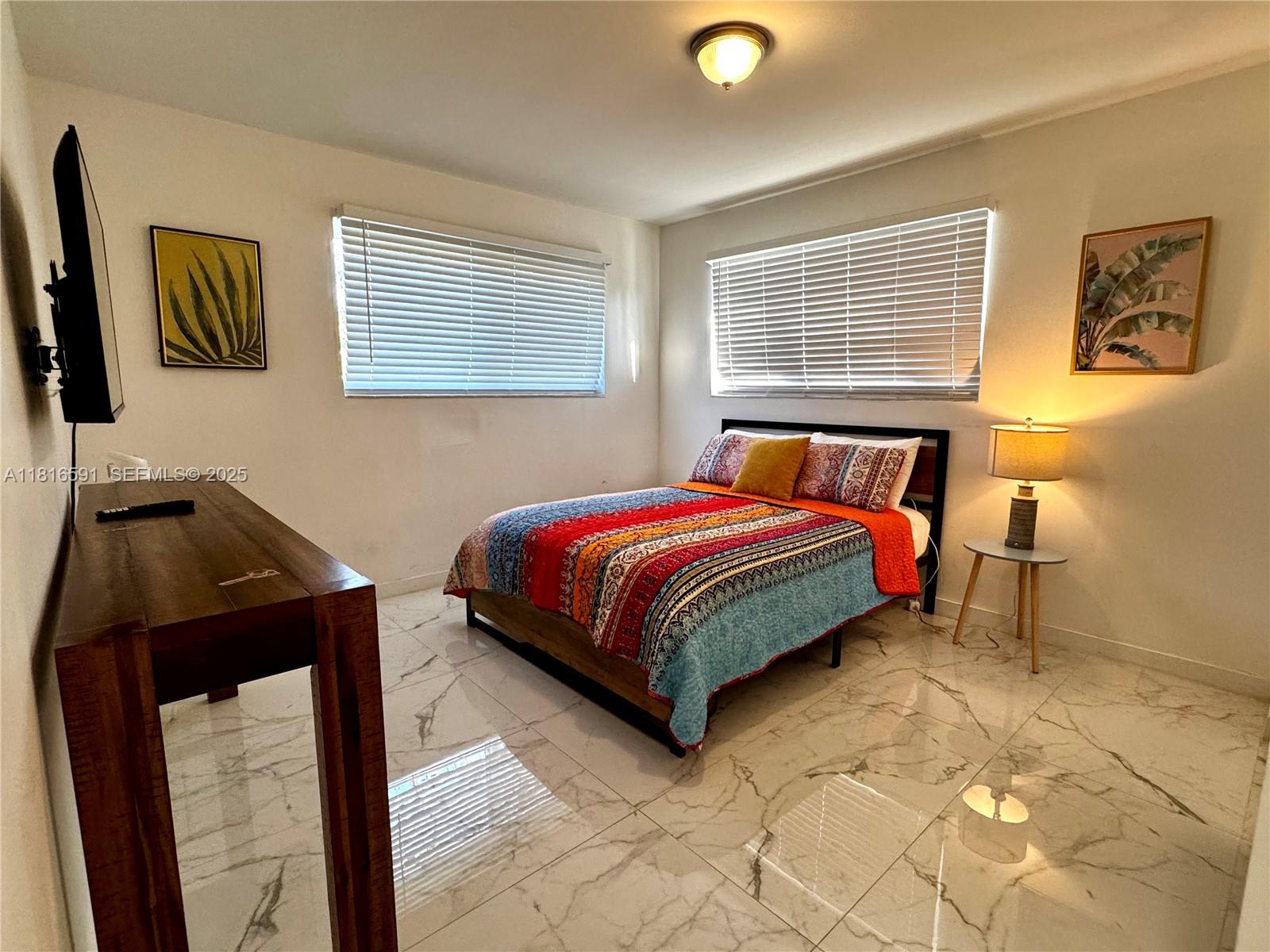 1012 Southwest 3rd Avenue Hallandale Beach, FL 33009 - Photo 11 of 35 a bedroom with a bed and wooden floor