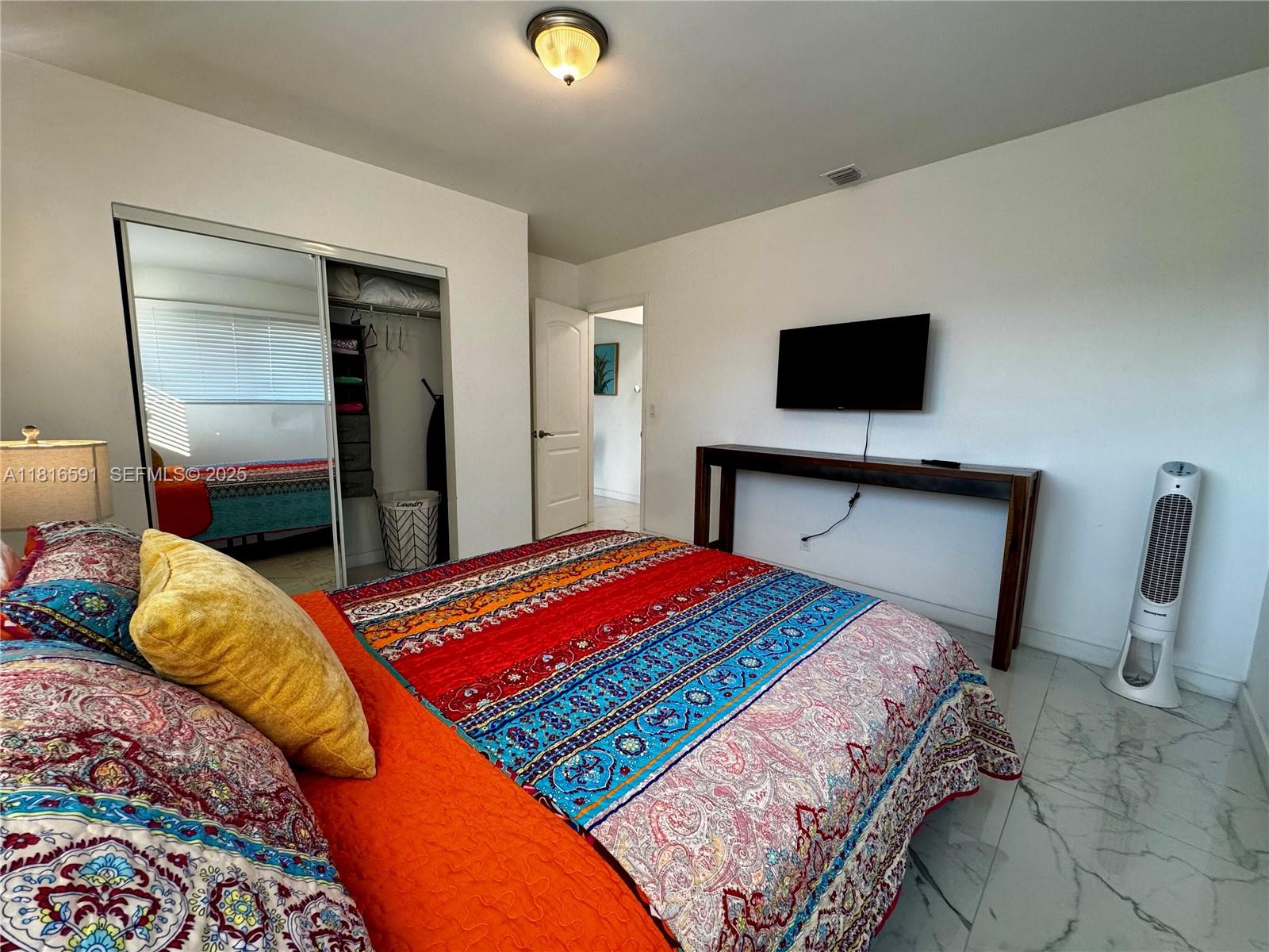 1012 Southwest 3rd Avenue Hallandale Beach, FL 33009 - Photo 12 of 35 a bedroom with a bed and a flat screen tv