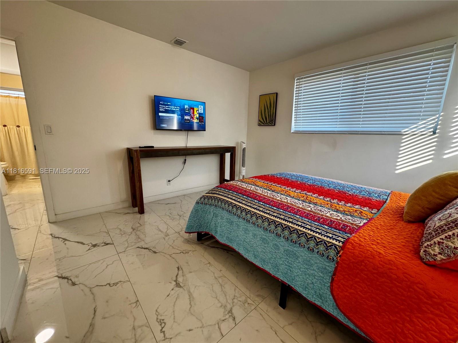 1012 Southwest 3rd Avenue Hallandale Beach, FL 33009 - Photo 13 of 35 a bedroom with a bed and a window