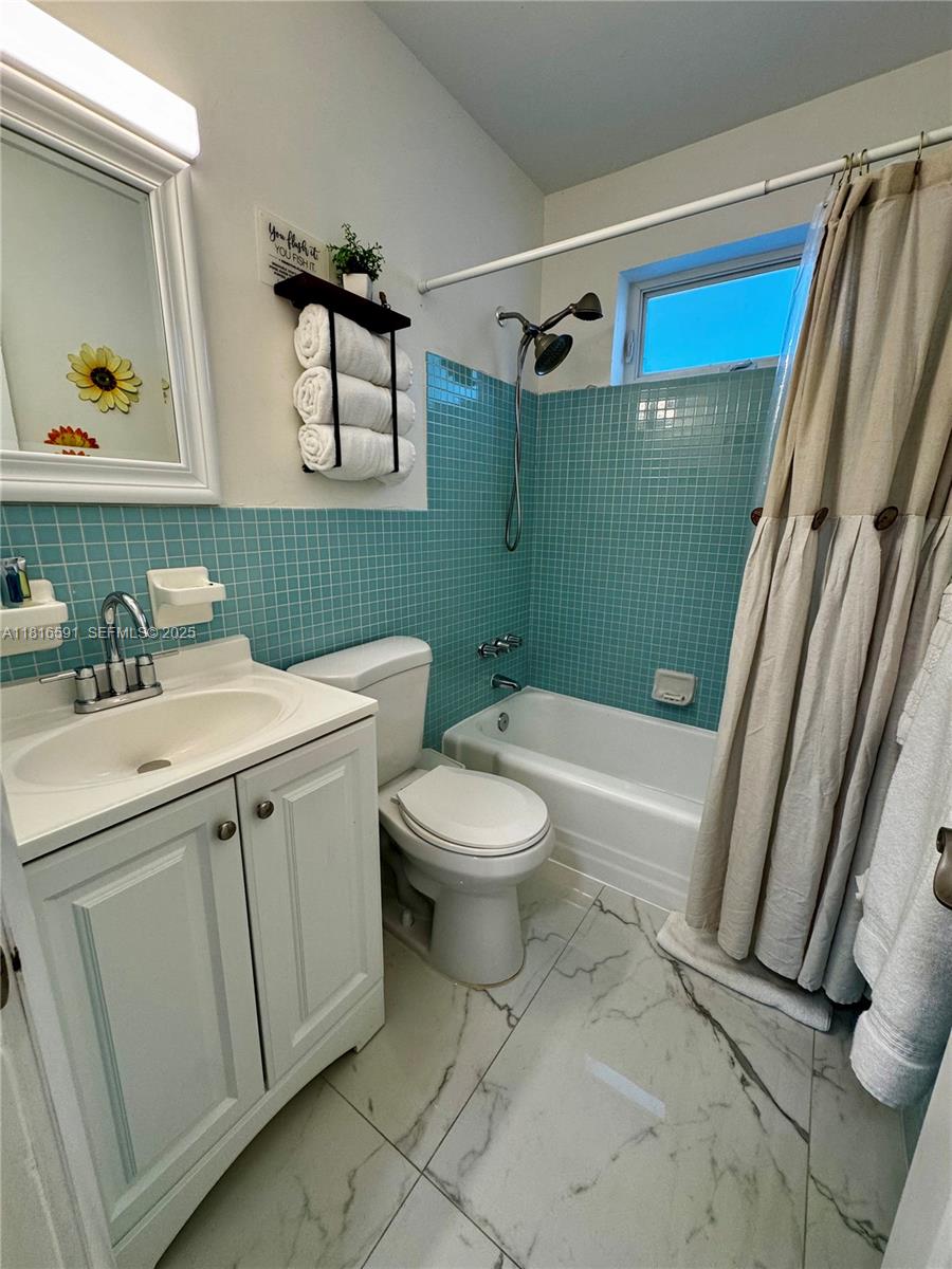 1012 Southwest 3rd Avenue Hallandale Beach, FL 33009 - Photo 14 of 35 a bathroom with a sink a toilet and a bathtub