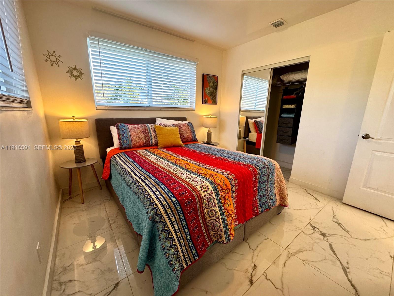 1012 Southwest 3rd Avenue Hallandale Beach, FL 33009 - Photo 15 of 35 a bed sitting in a bedroom next to a window