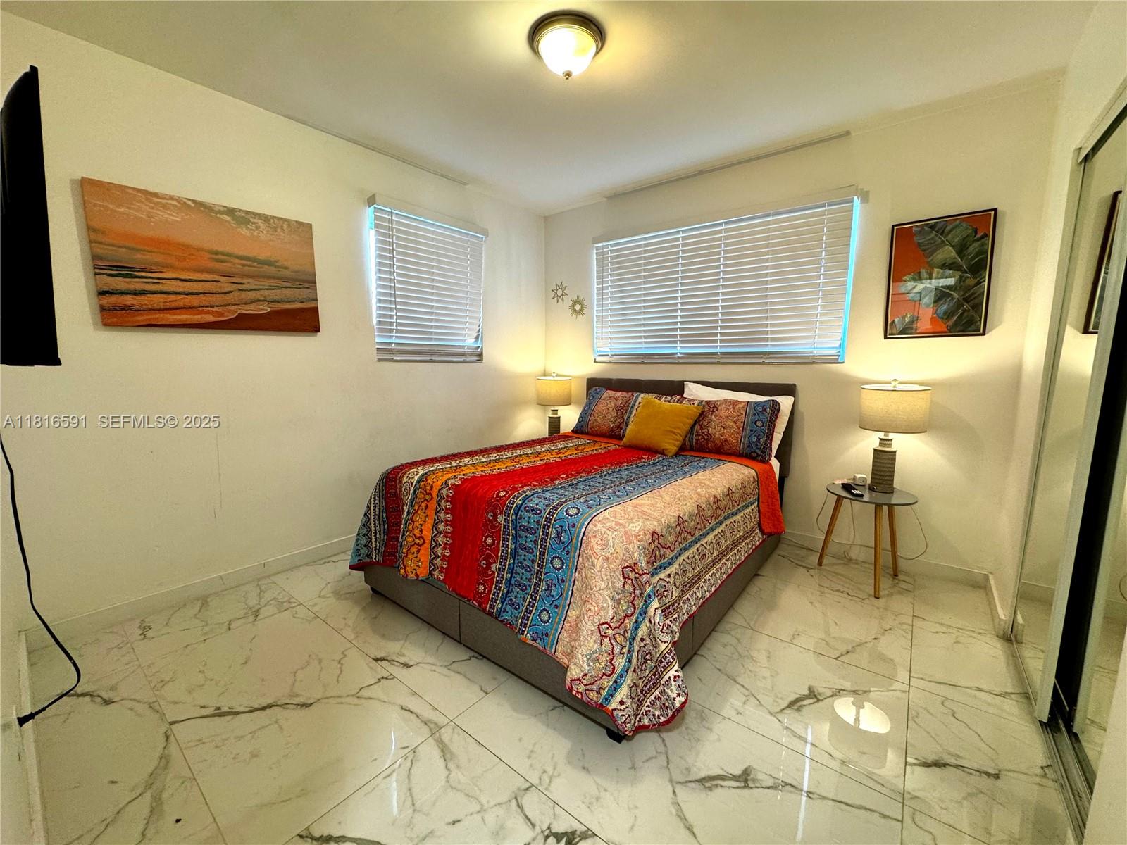 1012 Southwest 3rd Avenue Hallandale Beach, FL 33009 - Photo 16 of 35 a bedroom with a bed and a window