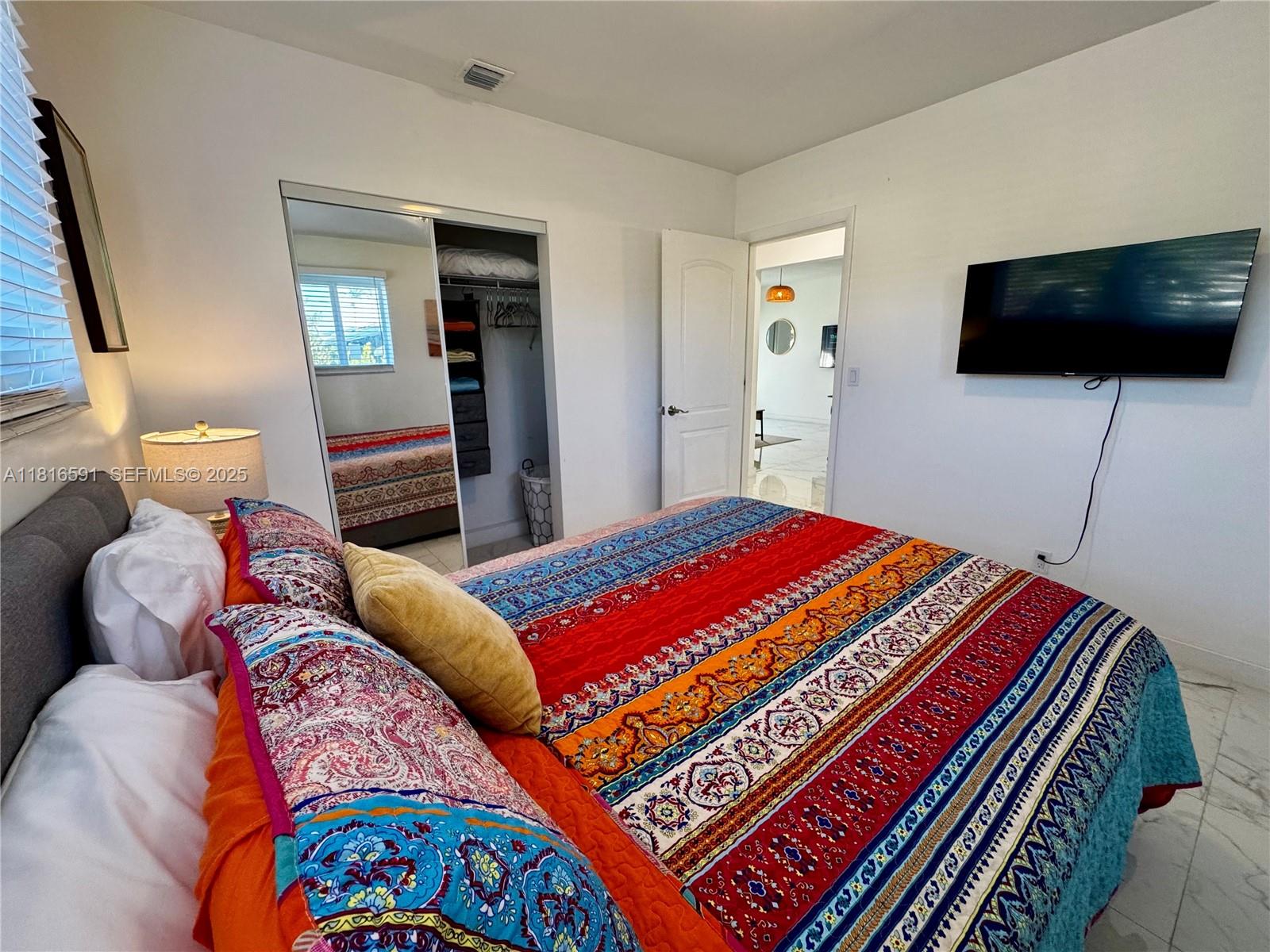 1012 Southwest 3rd Avenue Hallandale Beach, FL 33009 - Photo 17 of 35 a bedroom with a bed and flat screen tv