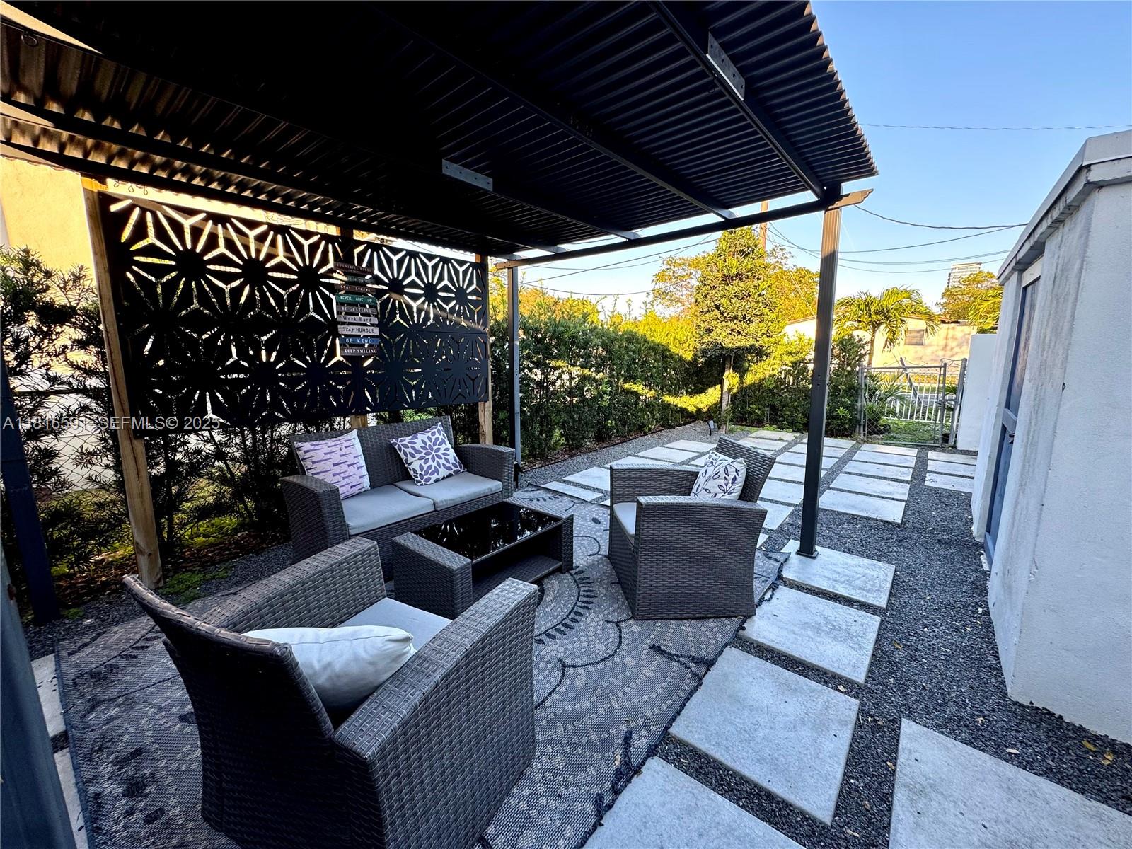 1012 Southwest 3rd Avenue Hallandale Beach, FL 33009 - Photo 18 of 35 a view of a patio with couches chairs and a potted plant