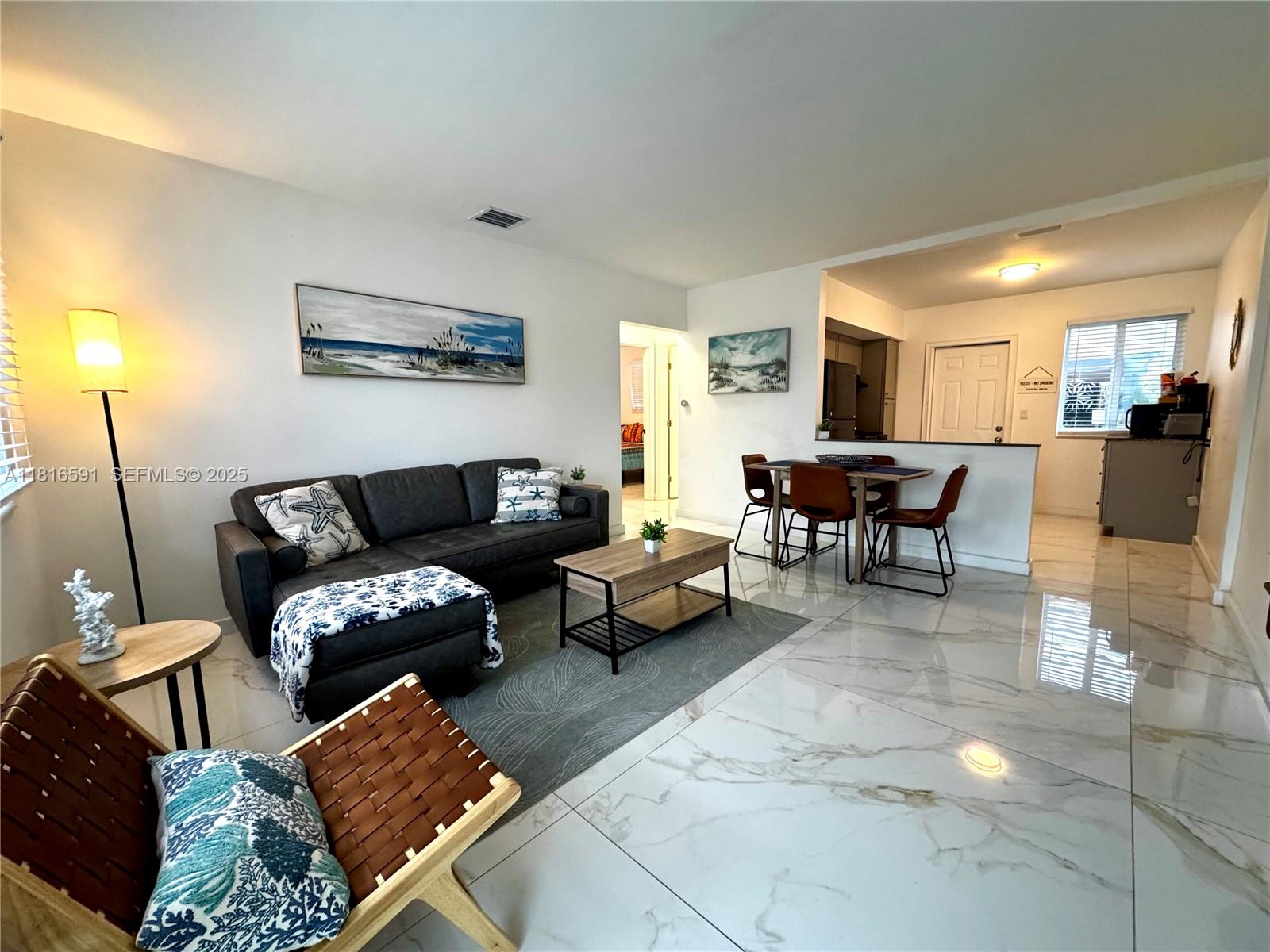 1012 Southwest 3rd Avenue Hallandale Beach, FL 33009 - Photo 23 of 35 a living room with furniture and a wooden floor