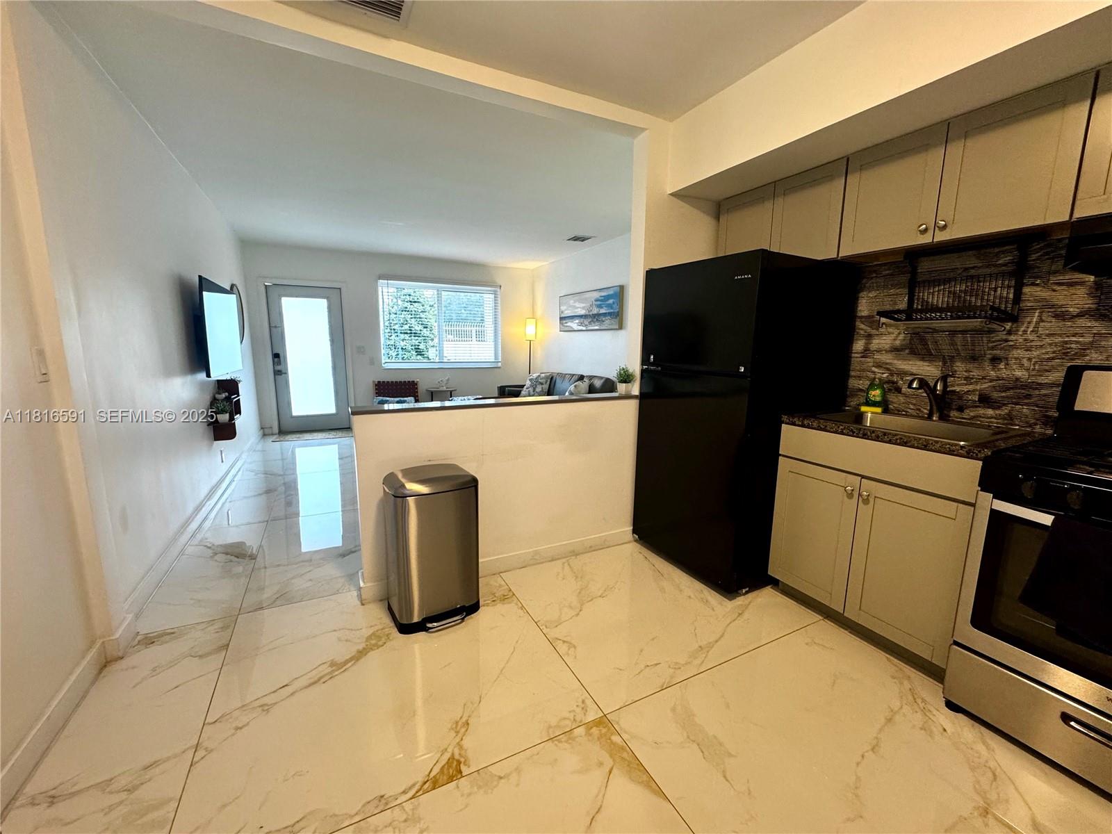 1012 Southwest 3rd Avenue Hallandale Beach, FL 33009 - Photo 27 of 35 a kitchen with a refrigerator and a stove