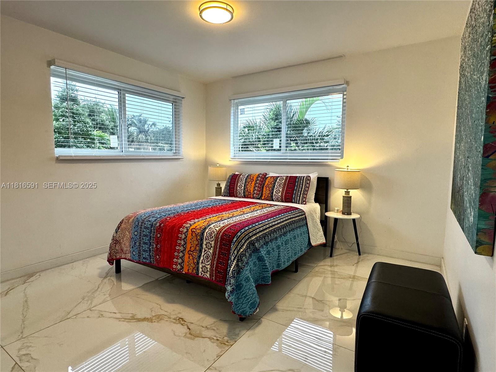1012 Southwest 3rd Avenue Hallandale Beach, FL 33009 - Photo 28 of 35 a bed sitting in a bedroom next to a window