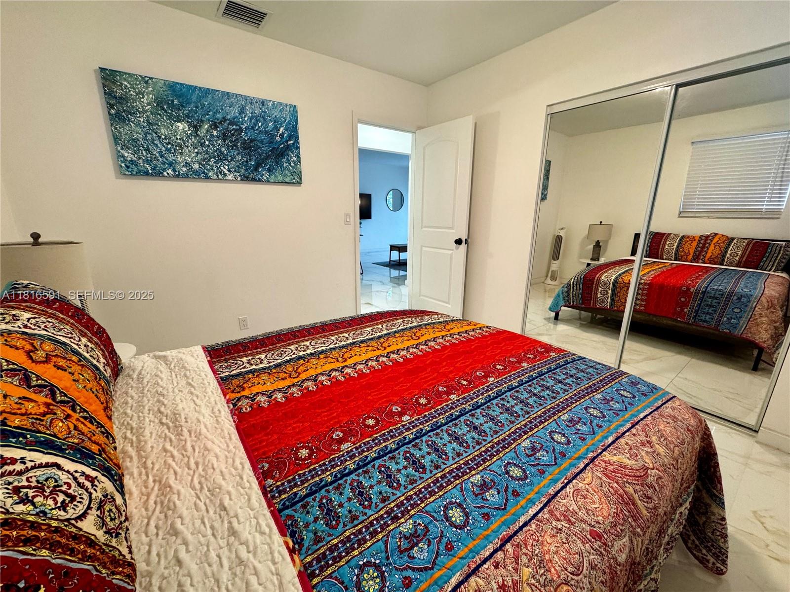 1012 Southwest 3rd Avenue Hallandale Beach, FL 33009 - Photo 32 of 35 a bedroom with a bed and a couch