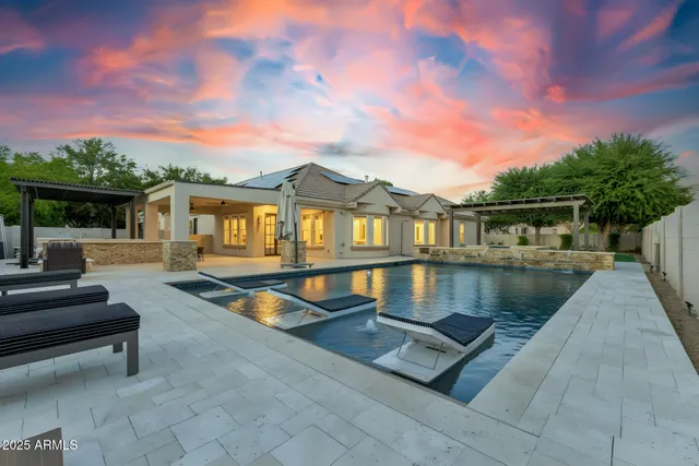a view of house with swimming pool and sitting area