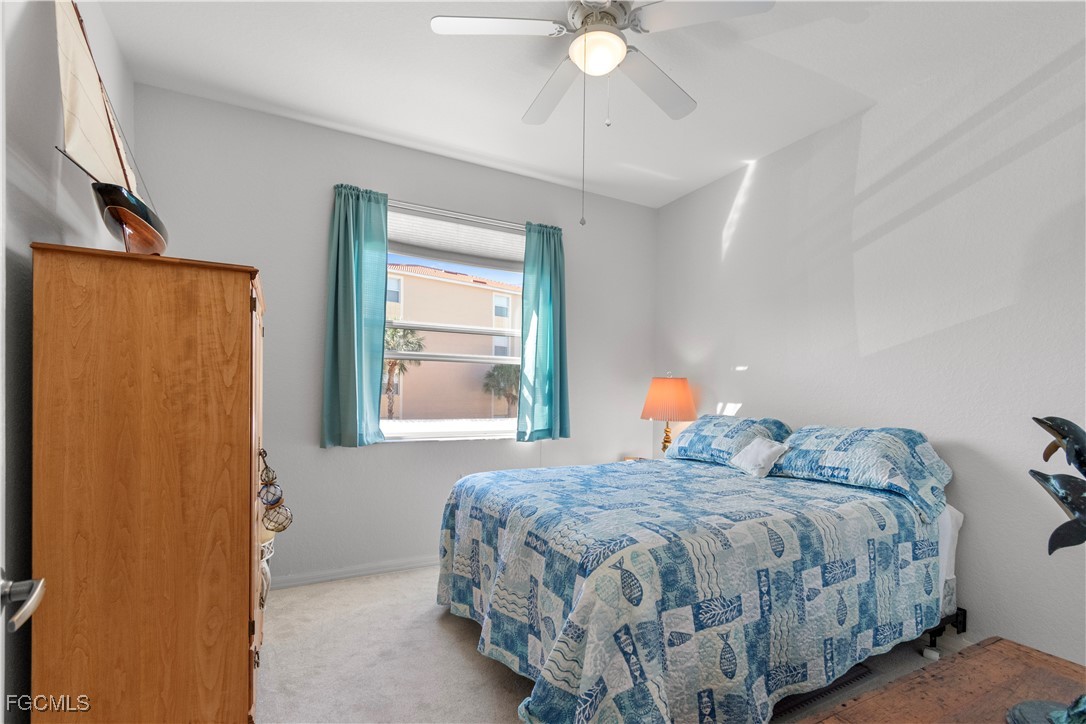 8261 Pathfinder Loop, Unit 730 Fort Myers, FL 33919 - Photo 21 of 40 a bedroom with a bed and a window