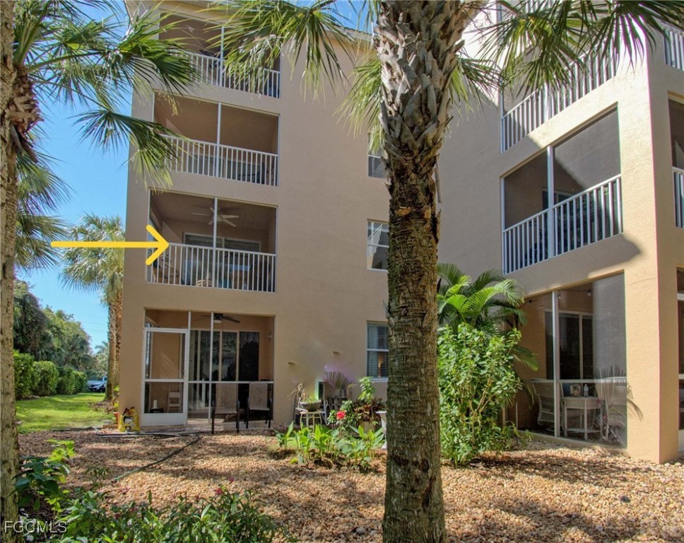 8261 Pathfinder Loop, Unit 730 Fort Myers, FL 33919 - Photo 25 of 40 a front view of a house with a yard