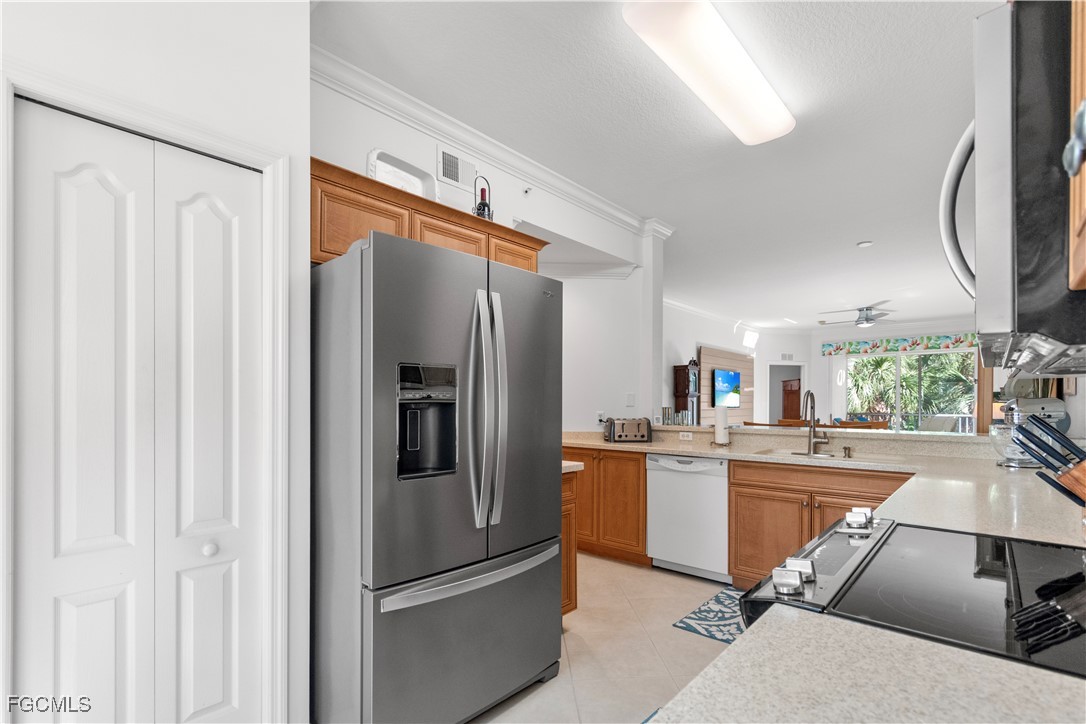 8261 Pathfinder Loop, Unit 730 Fort Myers, FL 33919 - Photo 7 of 40 a kitchen with stainless steel appliances a refrigerator and a sink