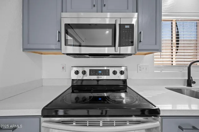 a stove top oven sitting inside of a kitchen
