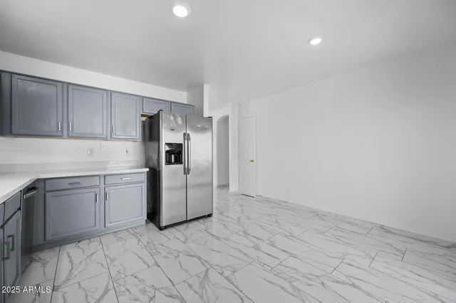 a kitchen with a stove top oven and cabinets