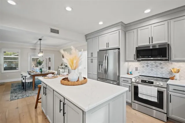 a kitchen with stainless steel appliances granite countertop a stove and a refrigerator