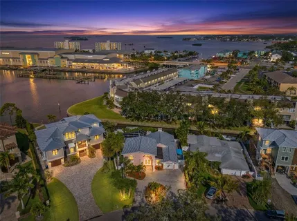 a view of staircase with lots of frames on wall and a window