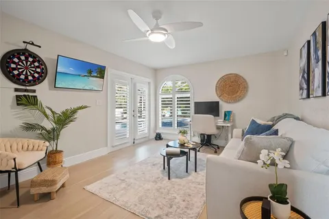 a living room with furniture windows and wooden floor
