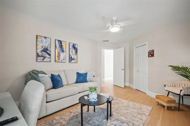 a living room with furniture and a potted plant