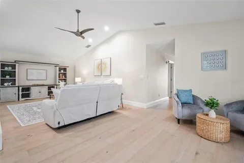 a view of a house with backyard and sitting area