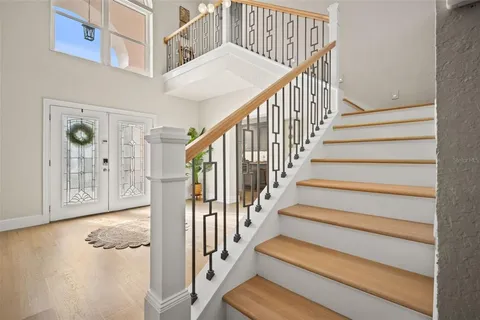 a view of a dining room with furniture a chandelier and wooden floor