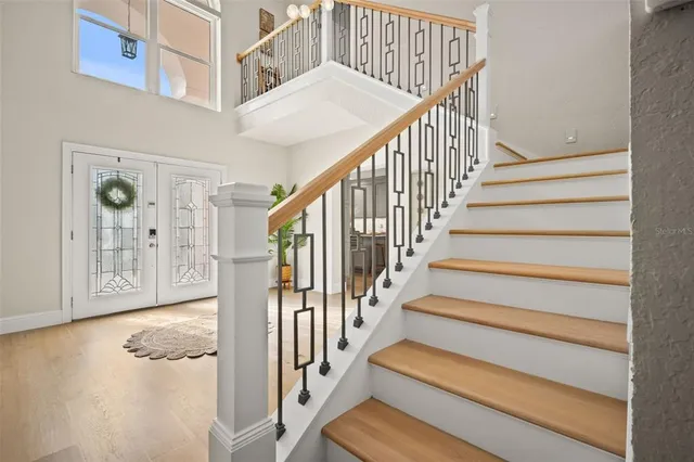 a view of a dining room with furniture a chandelier and wooden floor
