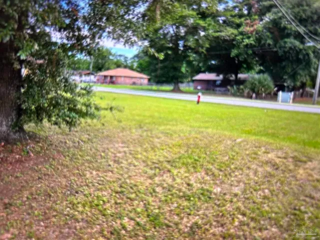 a swimming pool with outdoor seating and yard