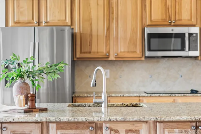 a kitchen with a sink and chairs
