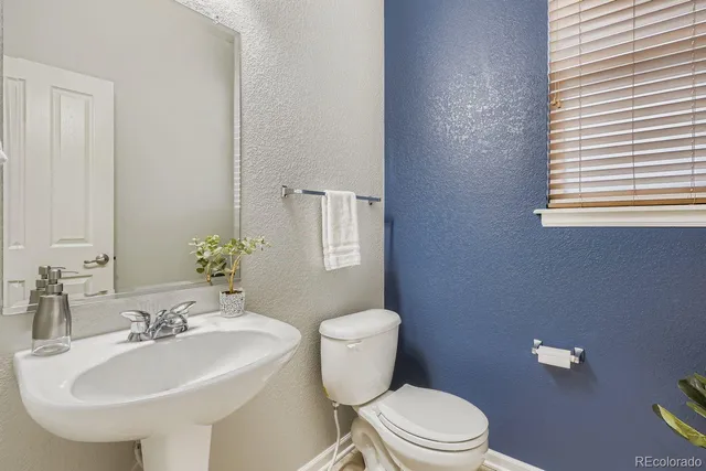 a living room with furniture a flat screen tv and a window
