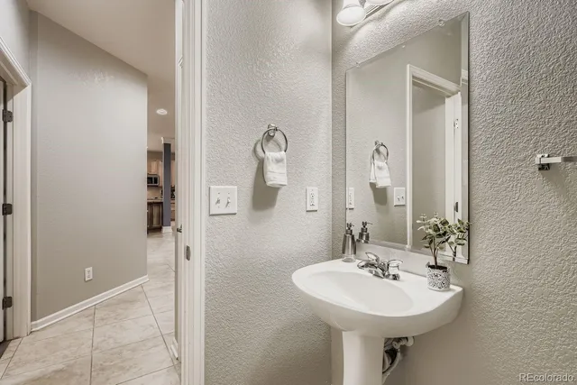 a living room with furniture a large window and a potted plant