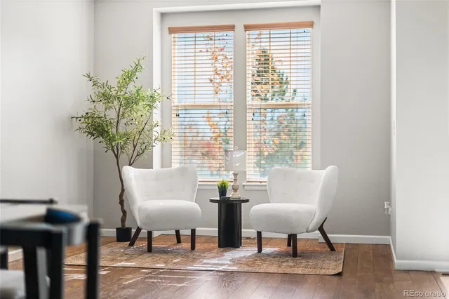 a kitchen with stainless steel appliances granite countertop a stove top oven a refrigerator a sink and a dining table with garden view