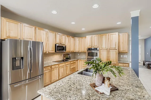 a dining room with furniture a chandelier and wooden floor