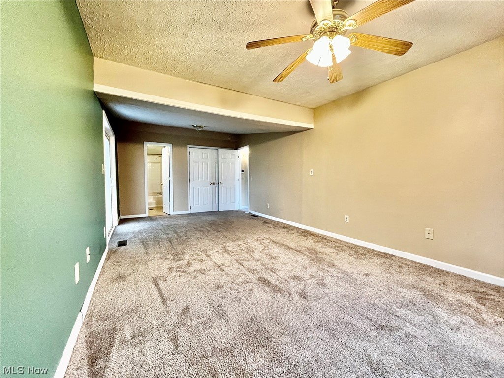 4214 School House Road Little Hocking, OH 45742 - Photo 16 of 29 Spare room with carpet floors, ceiling fan, and a textured ceiling