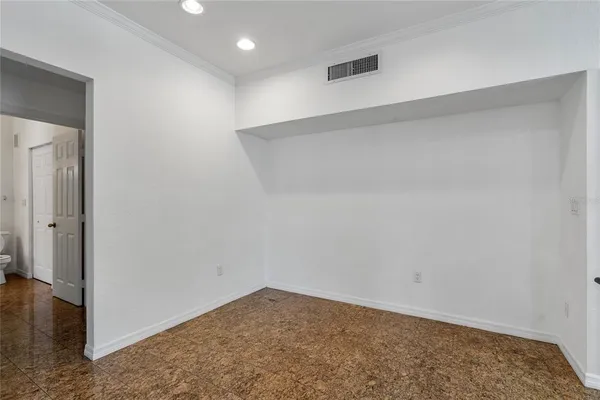 a view of a room with a chandelier fan