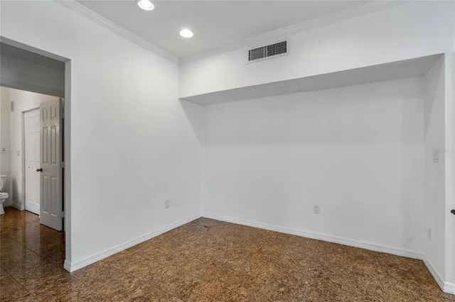 a view of a room with a chandelier fan