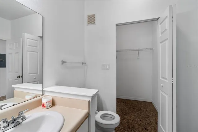 a view of a hallway with bathroom