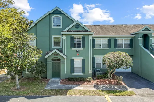 an aerial view of residential houses with outdoor space and swimming pool