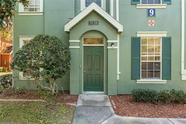 a view of kitchen with kitchen island stainless steel appliances sink cabinets and window