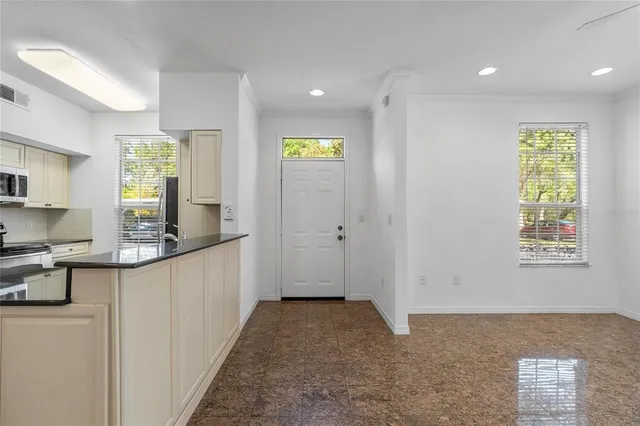 a kitchen with white cabinets and appliances