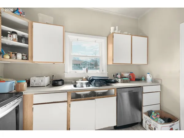 a kitchen with a sink cabinets and window