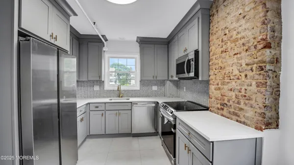 a kitchen with a sink stove and refrigerator