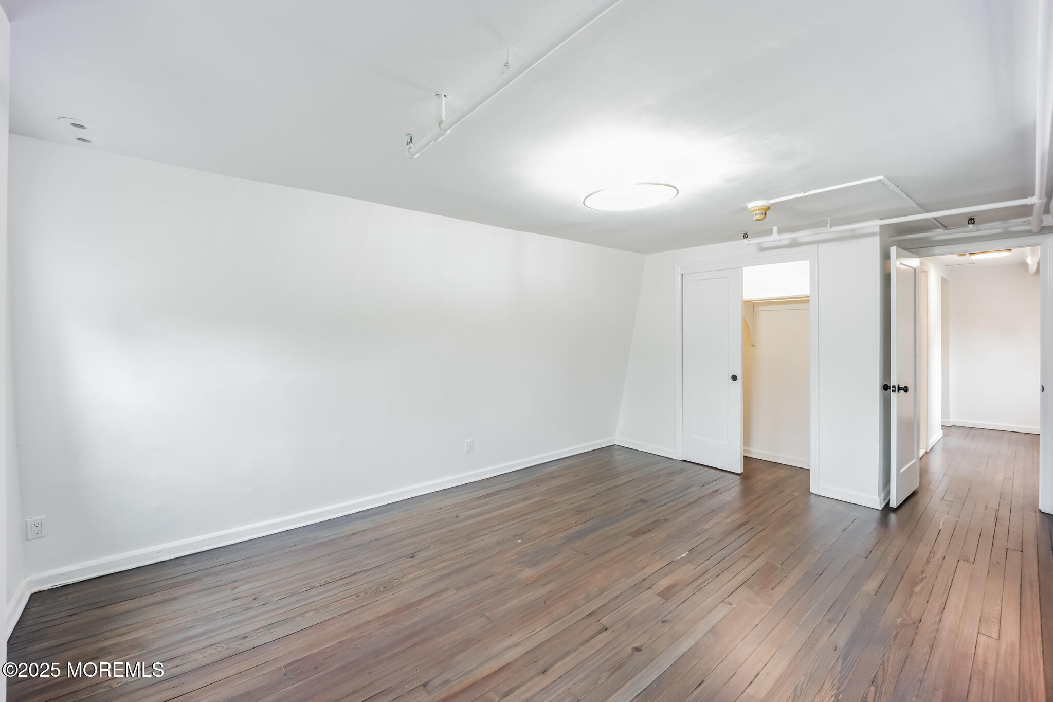87 Maple Avenue, Unit 2 Red Bank, NJ 07701 - Photo 6 of 28 a view of an empty room with wooden floor