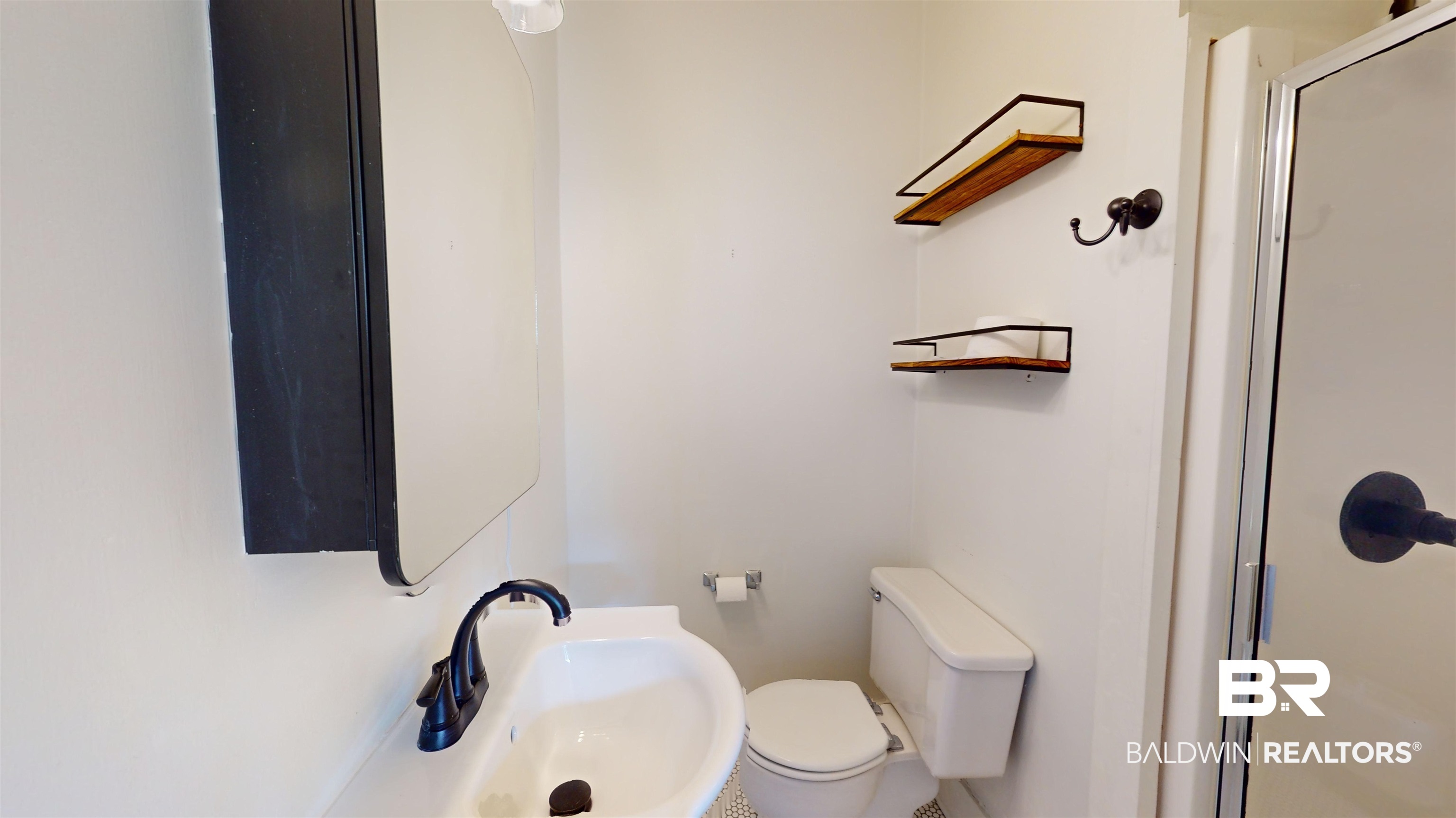 4307 Stein Street Mobile, AL 36608 - Photo 19 of 28 Bathroom featuring a shower with door, sink, and toilet