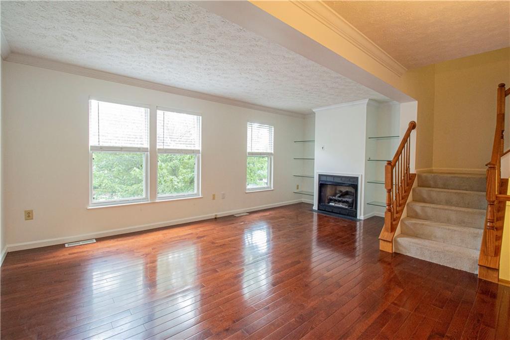 5 Hemingway Street Pittsburgh, PA 15213 - Photo 5 of 25 Main level living room with lots of light, hardwood floors, and fireplace
