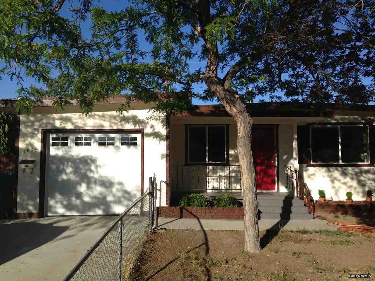 1820 Radcliffe Drive Reno, NV 89502 - Photo 1 of 1 a view of a building with floor to ceiling windows and a tree